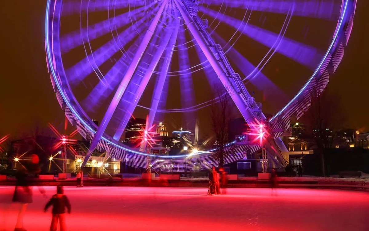 La Grande Roue de Montr&eacute;al lit up at night in the Old Port